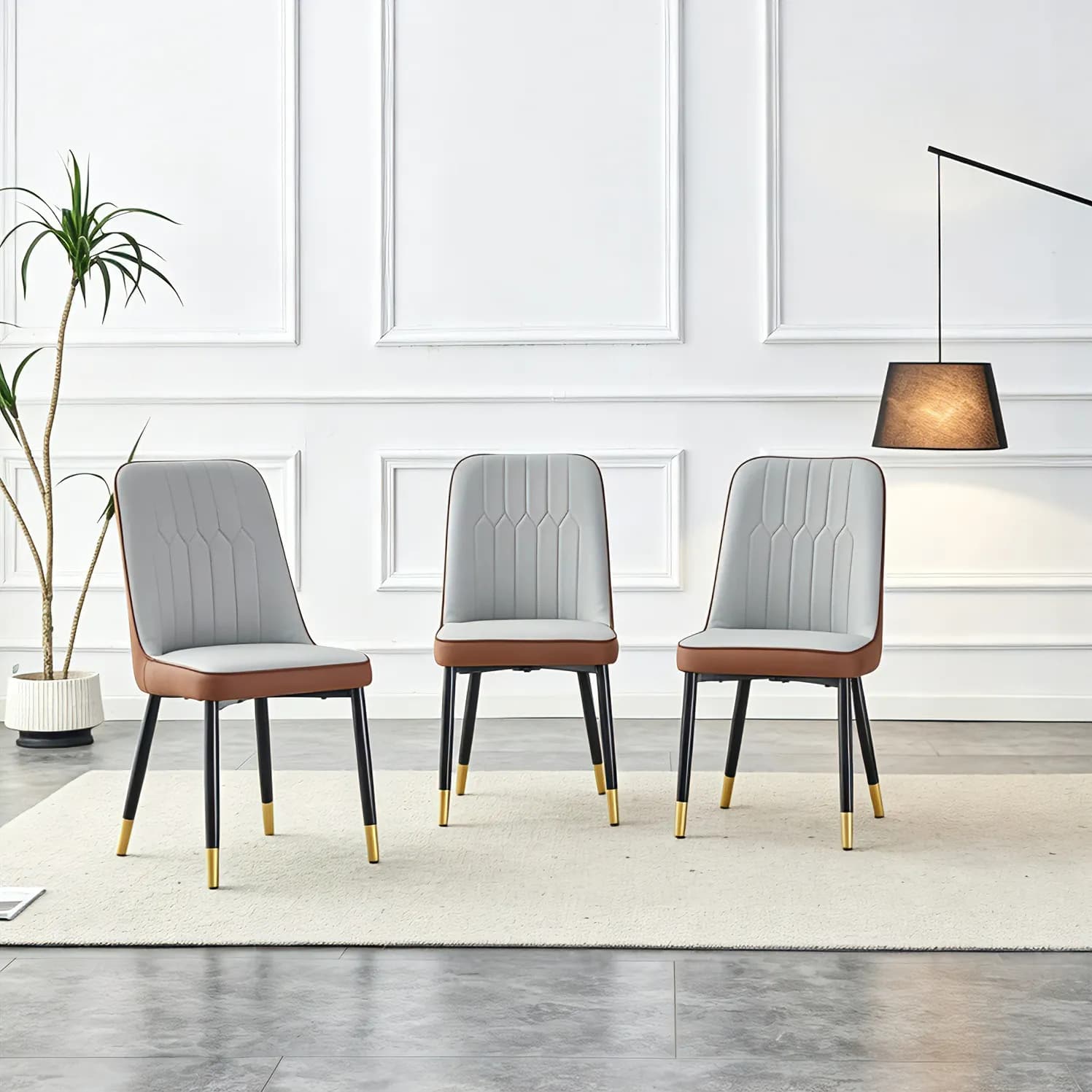 A modern dining chair with a light gray brown dual tone PU leather backrest and black…
