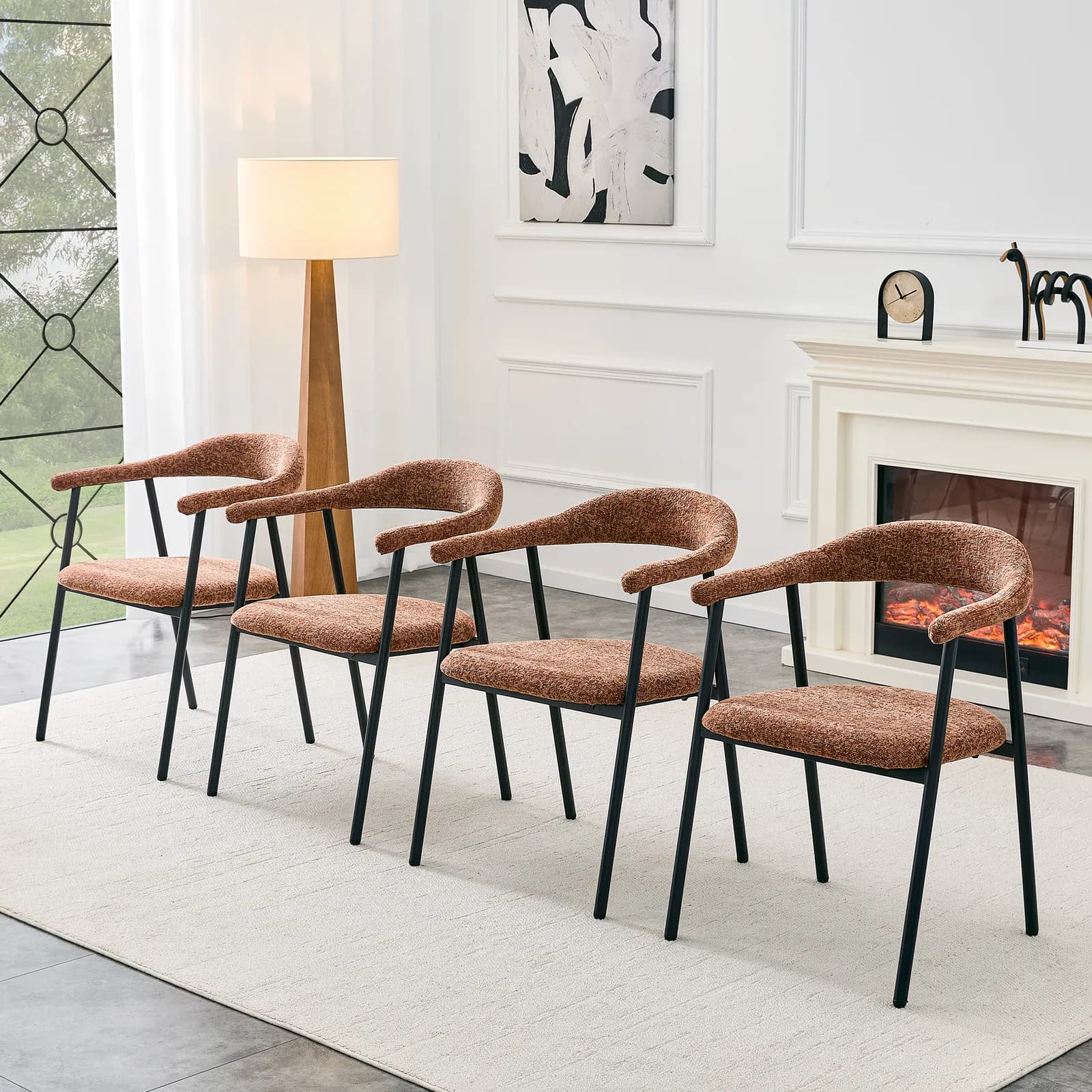 A 4-piece set of caramel-colored fabric dining chairs with sleek black metal legs,…