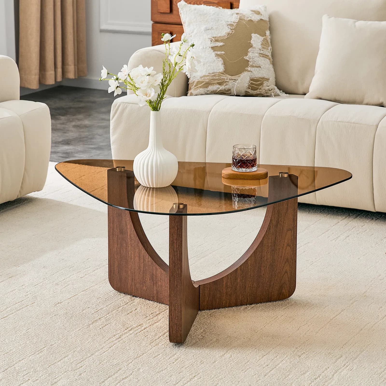 Vintage-style triangular coffee table with a tea-colored tempered glass top and…