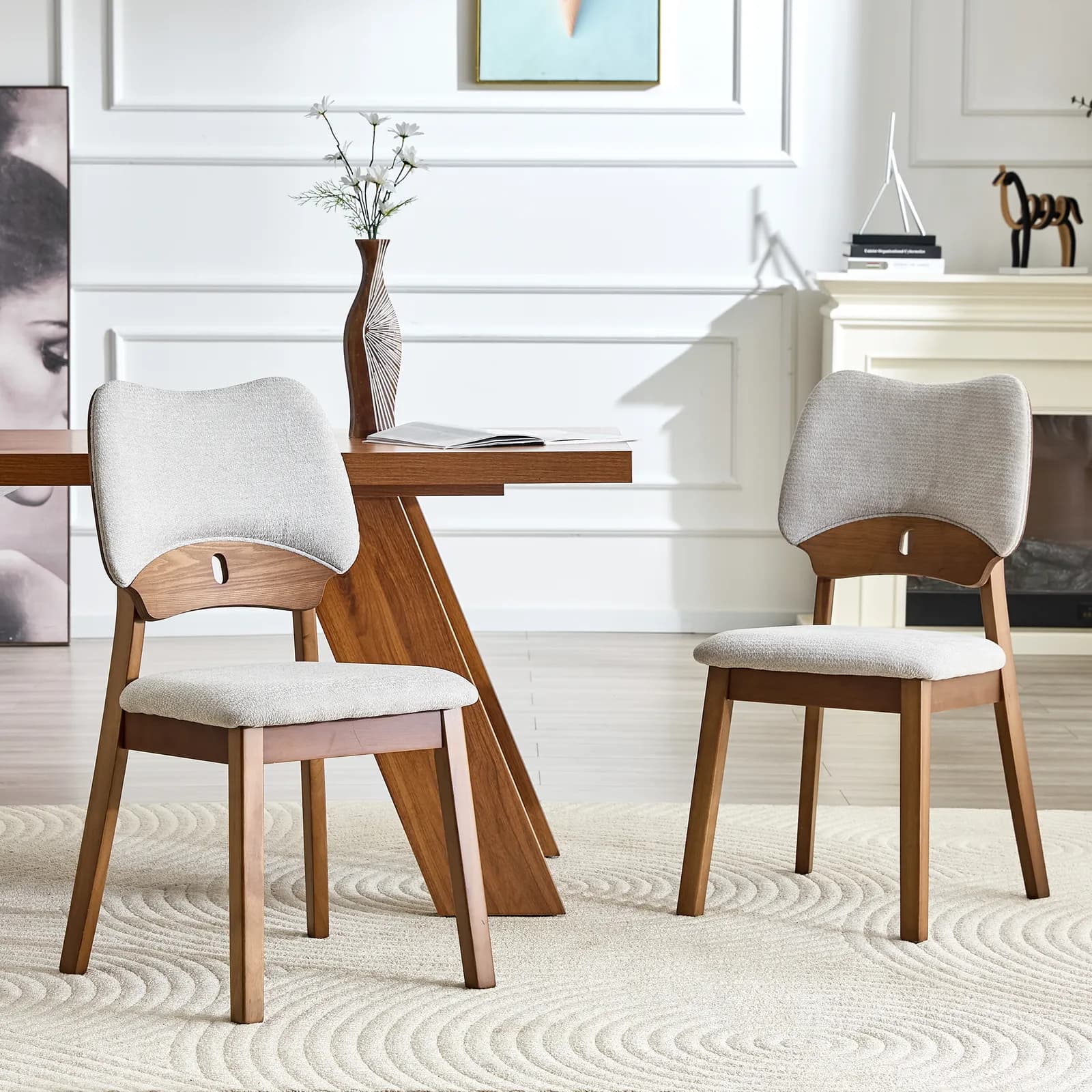 2 walnut colored solid wood dining chairs, with gray soft fabric packaging on the…
