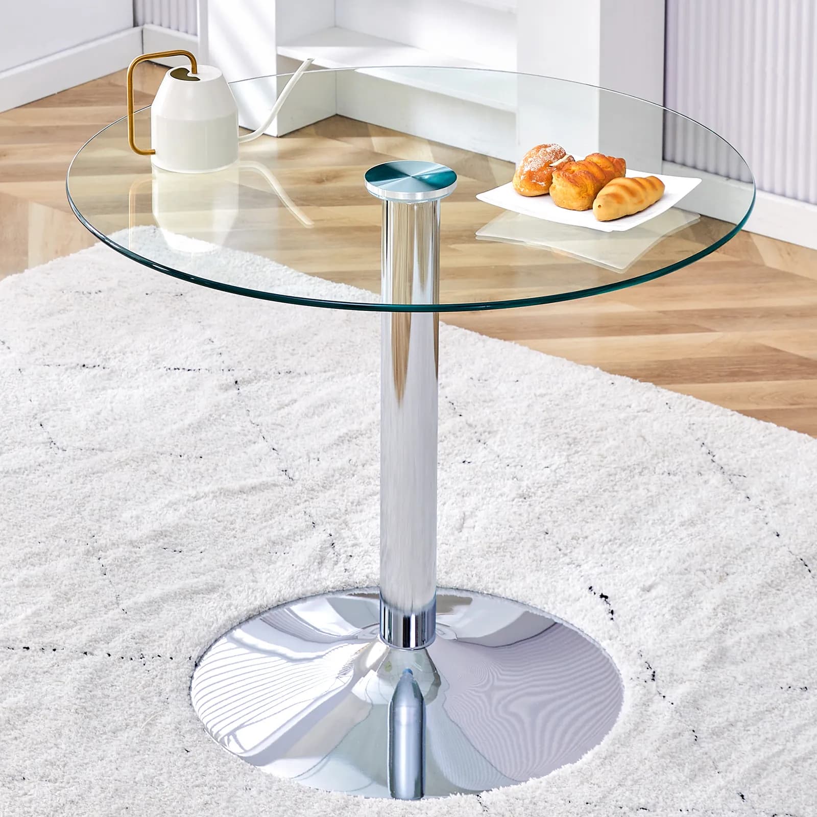 A 35-inch diameter glass top and a modern, minimalist round dining table with silver…