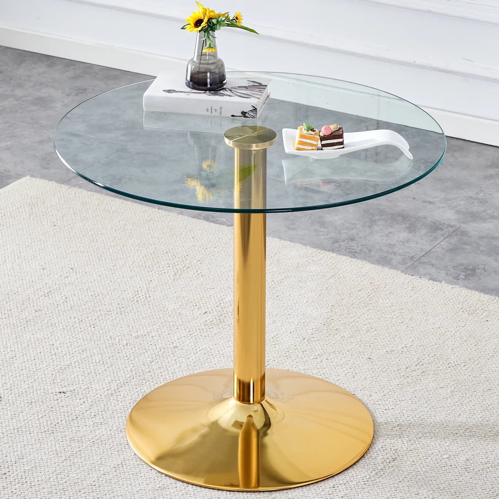 A 35-inch diameter glass top and a modern, minimalist round dining table with gold metal…