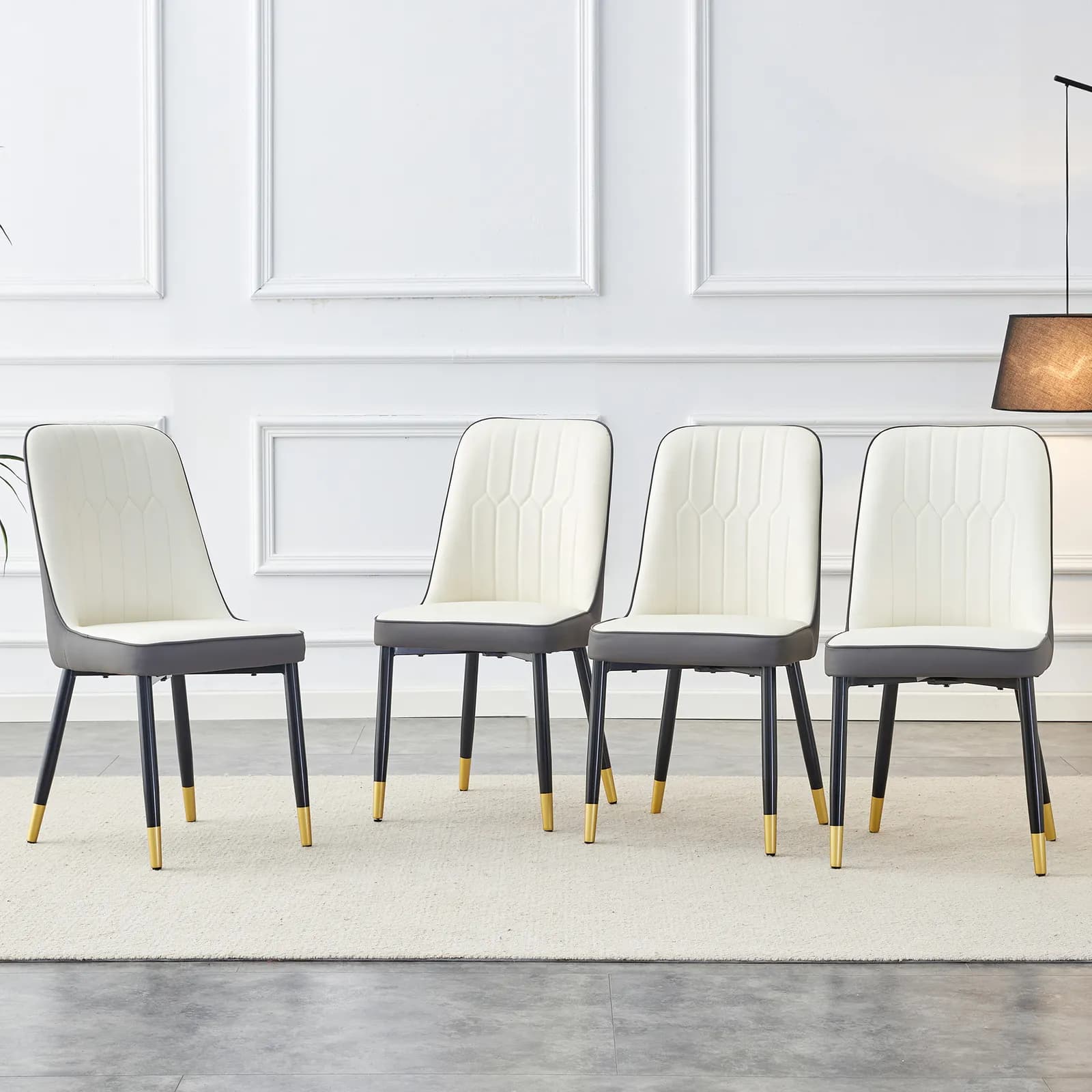 A modern dining chair with a white dark gray dual tone PU leather backrest and black…